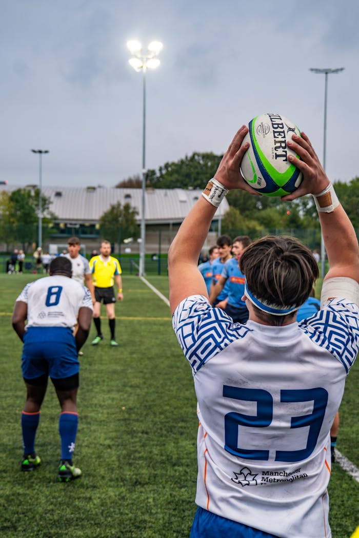 creative-03 Rugby player in action during a match, ready to throw the ball.